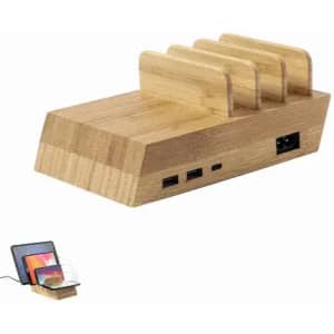A bamboo charging station with multiple slots and USB ports, featuring a sleek, natural wood finish.