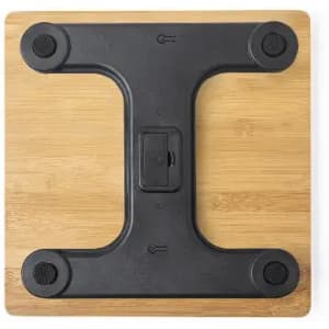 A black base with rubber grips on a wooden platform, designed for stability.