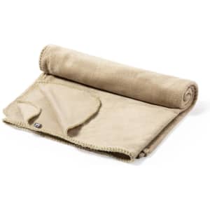 A rolled beige blanket made from soft fabric, featuring a stitched edge and a tag.