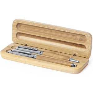 A bamboo pen set in an open case, featuring two pens with silver accents. The case has a smooth, natural finish.