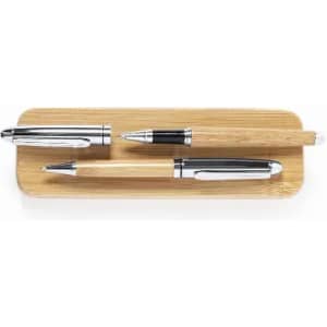 A set of three pens in silver and wood, displayed on a bamboo tray. The pens have sleek designs and a metallic finish.