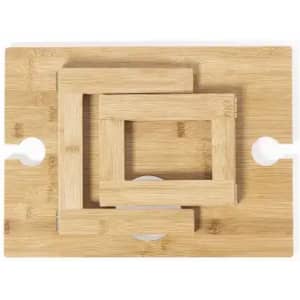 A wooden chopping board with three nested rectangular strips arranged in a pattern. It features round cut-out handles.