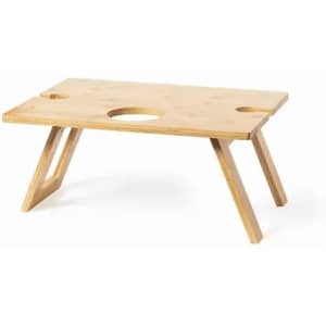 A wooden lap tray with a natural finish, featuring two circular cutouts and angular legs for support.
