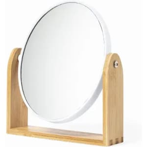 A round mirror with a wooden stand, featuring a sleek, minimalist design and natural bamboo base.