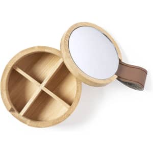 A round wooden storage box with a mirror lid and a leather handle, featuring four compartment sections inside.