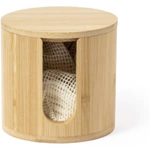 A round bamboo container with a lid, featuring a cut-out section revealing a white mesh pouch inside.