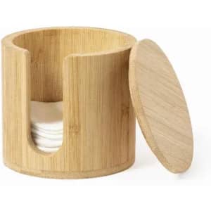 A bamboo container with a lid, featuring a slot and holding several cotton pads inside.