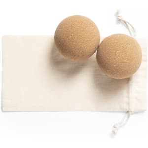 Two brown cork balls placed on a natural fabric pouch.