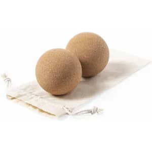 Two tan-coloured, spherical bath bombs resting on a natural fabric pouch. The pouch features a drawstring closure.