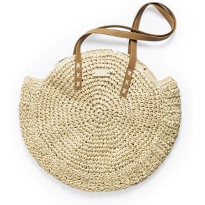 A straw bag featuring a circular design with brown straps. The bag has a textured finish and a natural beige colour.