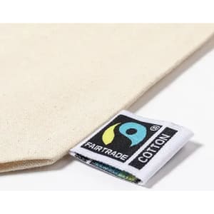 A neutral-coloured fabric with a Fairtrade cotton label visible in the corner.