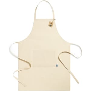 A beige apron with a front pocket and ties, featuring a small logo tag.