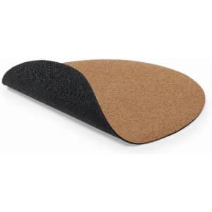 A cork mouse pad with a black fabric underside, featuring a rounded shape and a textured cork surface.