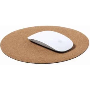 A round cork mouse pad with a white computer mouse resting on it. The surface is natural brown cork.