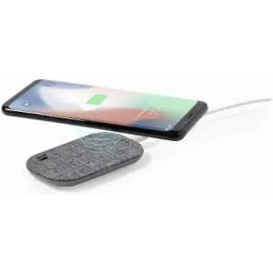 A wireless charger in grey with a phone above it displaying a charging indicator. The charger has a branding logo.