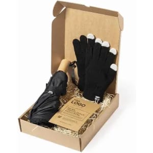 A gift box containing a black umbrella and black gloves with white tips, arranged with straw.