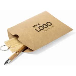 A brown kraft envelope containing a wooden pen and keychain. The envelope features a logo design.
