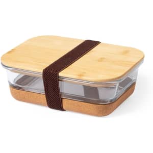 A glass food container with a bamboo lid, featuring a cork base and a brown strap.