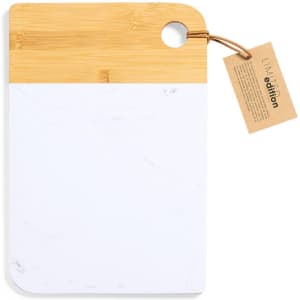 A cutting board with a bamboo handle and a white marble surface, featuring a tag attached for details.