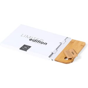 A bamboo chopping board in a white box, featuring a tag and a logo. The box is marked "Limited Edition".