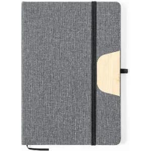 A grey notebook with a textured cover, featuring a wooden accent and an elastic band closure.