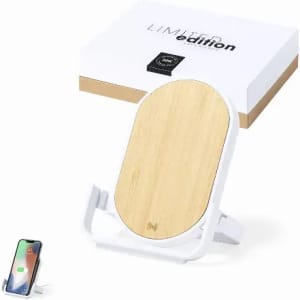 A wireless phone charger with a bamboo top and white base, presented in a branded box.