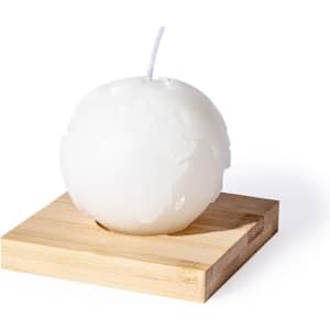 A spherical white candle shaped like a globe, mounted on a wooden base.