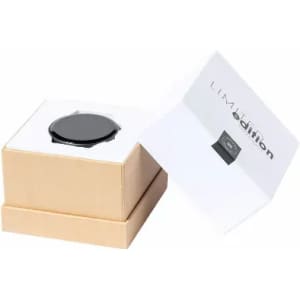 A black watch nestled in a light brown box, with an open lid revealing a white interior and branding.