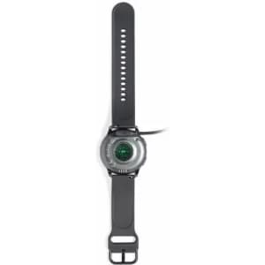 A grey sports watch with a round face and a black strap, featuring a green display and various strap holes.