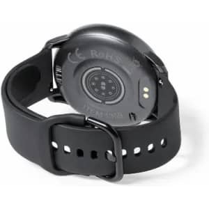 A fitness watch in black with a circular back featuring sensors and a strap with adjustment holes.