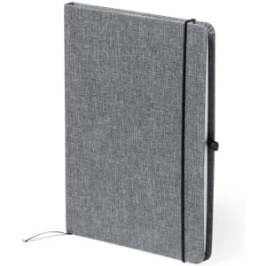 A grey notebook with a textured cover, featuring an elastic band and a ribbon bookmark. It has a logo on the cover.