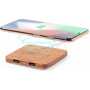 A wireless charging pad made from wood with two USB ports, along with a smartphone hovering above it.