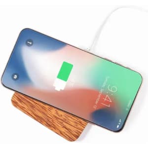 A phone charging on a wooden wireless charger, featuring a high-resolution screen and battery indicator.