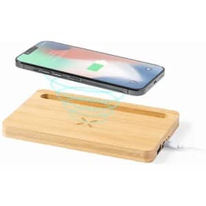 A wireless charging pad made of bamboo with a smartphone hovering above it, indicating charging functionality.
