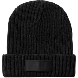 A black knit beanie with a ribbed texture and a fold-up cuff featuring a patch.