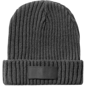 A beanie hat in dark grey with a ribbed texture and a folded brim. The hat features a blank patch for branding.