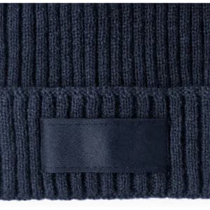 A dark navy beanie made of ribbed knit fabric, featuring a plain band without any visible branding.
