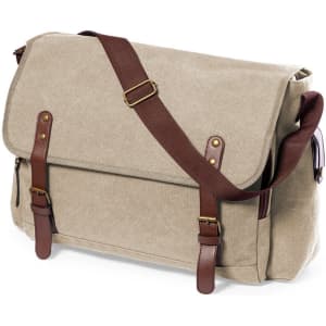 A messenger bag in beige canvas with brown leather accents and adjustable strap. Features a flap and buckle closures.