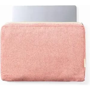 A laptop sleeve in a soft pink hue with a zipper closure, featuring a simple design and a logo.
