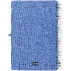 A blue spiral-bound notebook with a textured cover and an elastic band. Features a logo on the front.