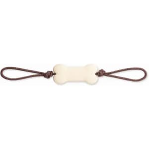 A dog toy featuring a bone-shaped centre in cream, with brown loops on either end for easy grip.