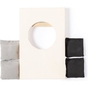 A game board with a circular hole, paired with four bean bags in grey and black. The board has a wooden handle.