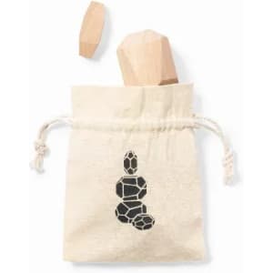 A drawstring canvas bag containing two wooden pieces, one shaped like a crystal, in a natural colour.