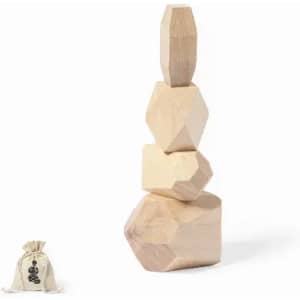 A stack of wooden geometric shapes in natural tones, alongside a small bag.