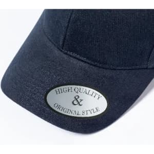 A dark navy cap featuring a shiny silver badge with the words "High Quality & Original Style".
