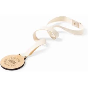 A medal with a circular wooden pendant and a cream strap. The pendant features a logo.