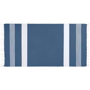 A blue and white patterned beach towel with fringe details on the edges. It features striped designs.
