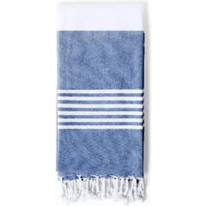 A towel featuring a blue and white striped design with tasselled edges. It has a clean, modern aesthetic.