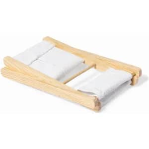 A wooden bed frame with two white cushions, designed for a miniature or decorative display.