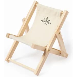 A wooden deck chair with a cream fabric seat, featuring a simple leaf design. The chair is in a folded position.